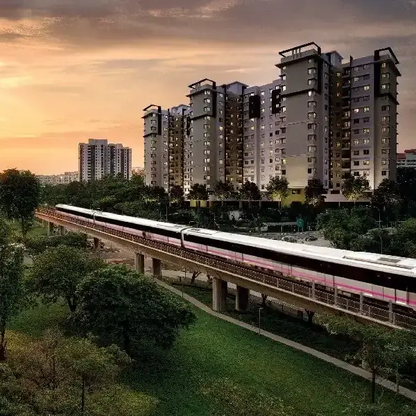 Provident Sunworth City towers at sunset beside the metro line, artist’s impression